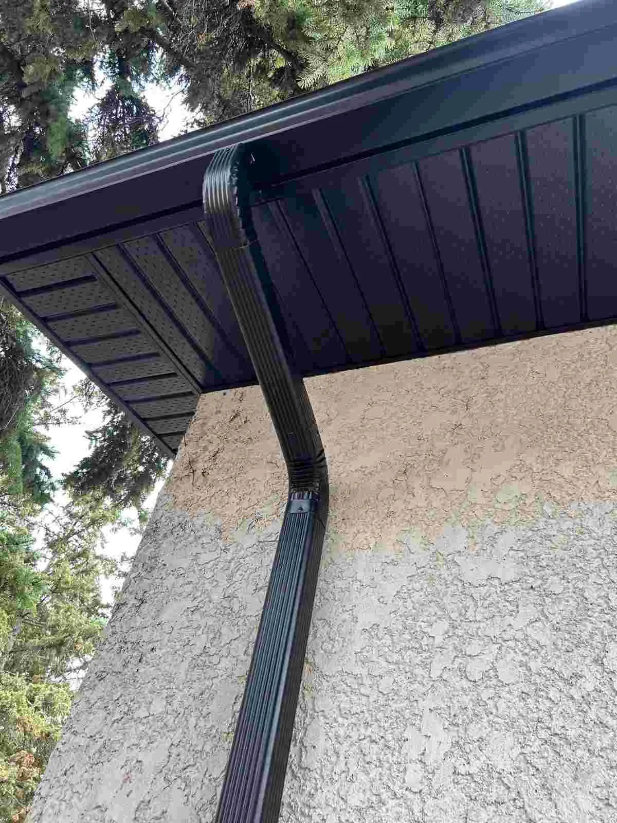 Vented aluminum soffit panels and fascia trim close-up on a Winnipeg home